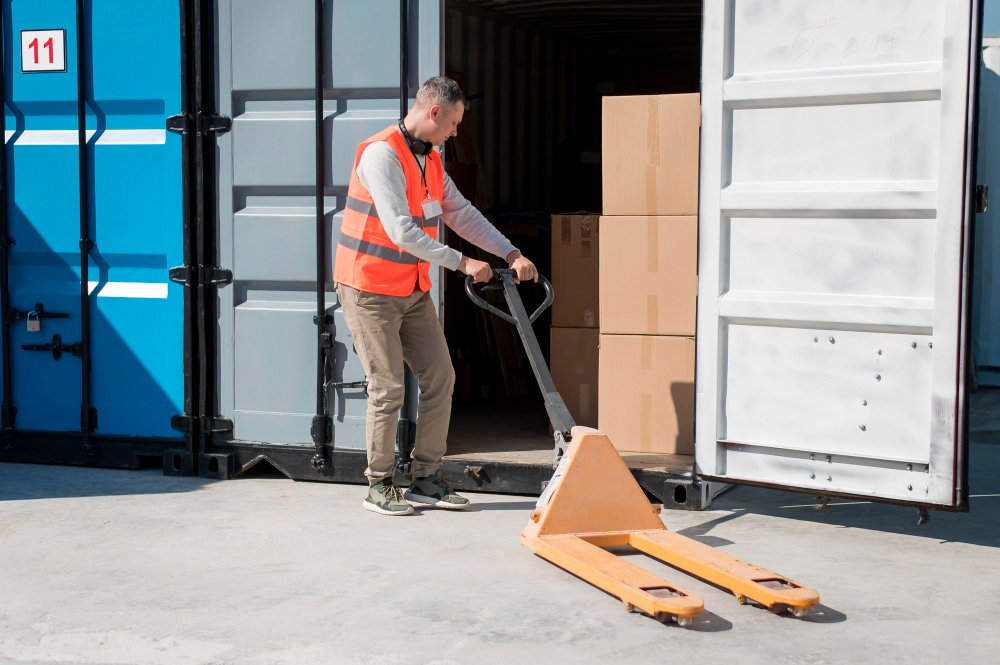 full-shot-man-carrying-pallet-truck